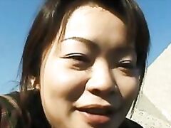 Mature Tomomi Kobayashi takes a piss after masturbating on a beach.