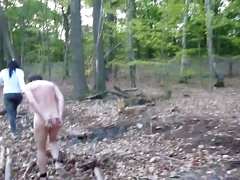 Nude male slave on leash in forest